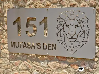 a sign on the side of a building with a lion at Mufasa's Den Zebula in Warmbaths