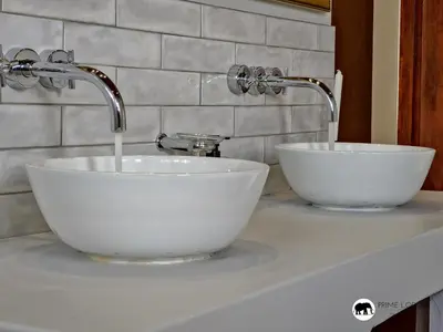a white sink with two faucets on a counter at Mufasa's Den Zebula in Warmbaths