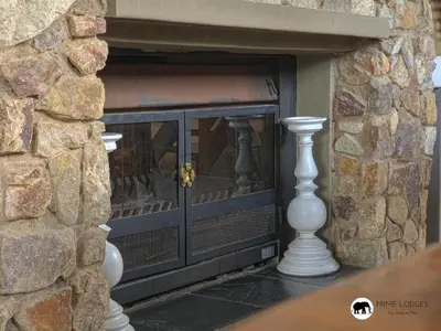 a fireplace with two white vases in a stone wall at Mufasa's Den Zebula in Warmbaths