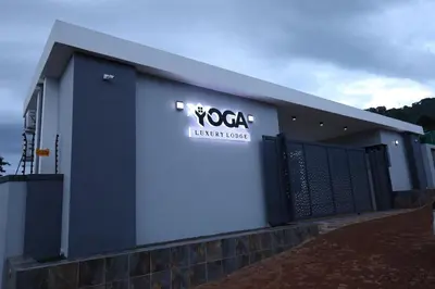 a building with a sign on the side of it at Yoga Luxury Lodge in Thohoyandou
