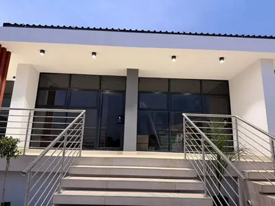 a house with glass doors and stairs in front at Yoga Luxury Lodge in Thohoyandou