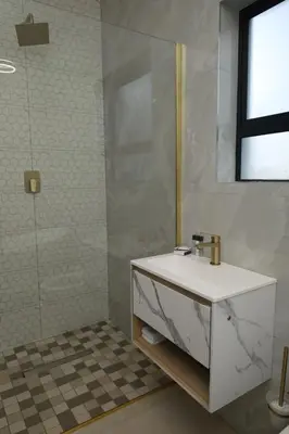 a bathroom with a sink and a shower at Yoga Luxury Lodge in Thohoyandou