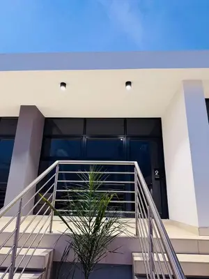a staircase with a plant in front of a building at Yoga Luxury Lodge in Thohoyandou