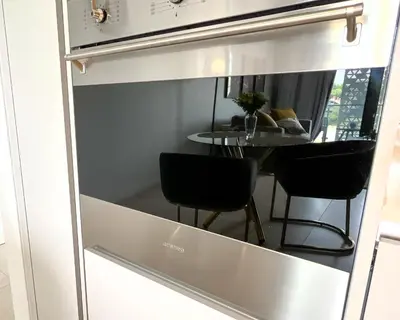 a kitchen window with two chairs and a table at 4208 on Ellipse, Waterfall, Midrand in Midrand