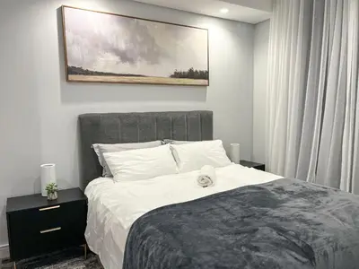 a bedroom with a bed with a stuffed animal on it at 4208 on Ellipse, Waterfall, Midrand in Midrand