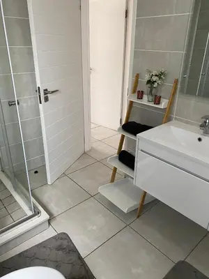 a bathroom with a toilet and a sink and a shower at IRIS at THE BLYDE in Pretoria