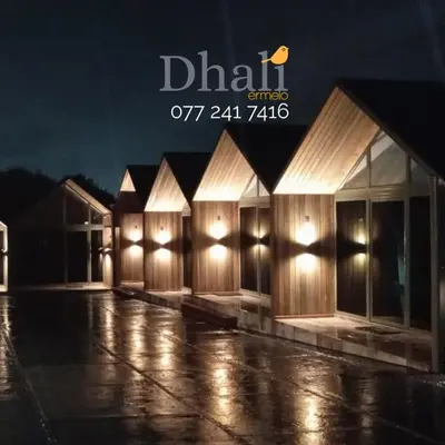 a row of buildings in the rain at night at DHALI COUNTRY house in Ermelo