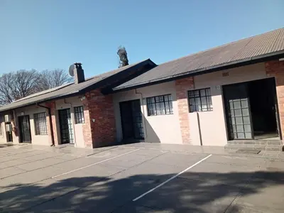 an empty parking lot in front of a brick building at DHALI COUNTRY house in Ermelo