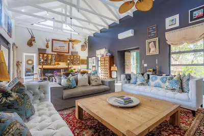 a living room with couches and a coffee table at Bushveld Villa w Pool, Firepit & Outdoor Living in Hoedspruit