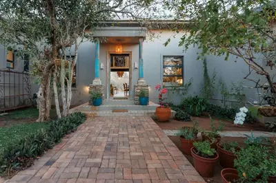 a home with a brick walkway leading to the front door at Bushveld Villa w Pool, Firepit & Outdoor Living in Hoedspruit