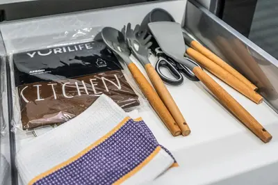 a table with scissors and a package of kitchen utensils at Menlo Park Luxury Free Parking King bed Workstation 3 km to Menlyn Maine in Pretoria