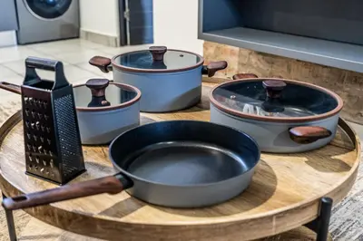 a table with four pots and a pan on it at Menlo Park Luxury Free Parking King bed Workstation 3 km to Menlyn Maine in Pretoria