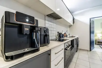 a kitchen with a microwave oven and a stove at Menlo Park Luxury Free Parking King bed Workstation 3 km to Menlyn Maine in Pretoria