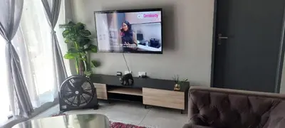 a living room with a flat screen tv on a wall at Circa apartment unit 42 in Pretoria