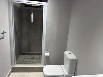 a bathroom with a shower and a toilet in it at Circa apartment unit 42 in Pretoria
