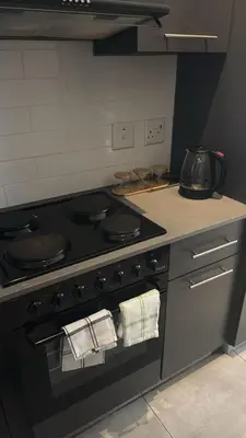 a kitchen with a stove with towels on the oven at Circa apartment unit 42 in Pretoria