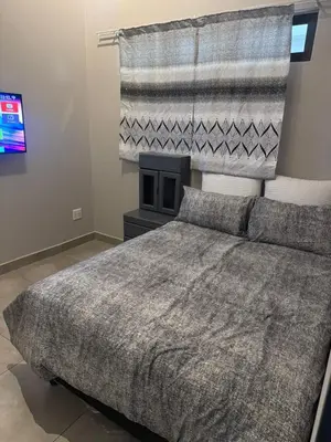 a bedroom with a large bed and a television at Circa apartment unit 42 in Pretoria
