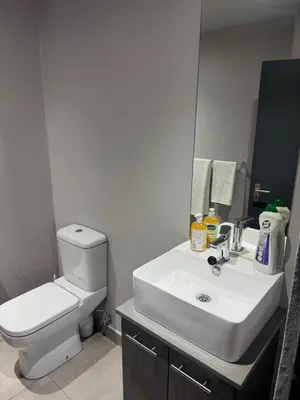 a bathroom with a sink and a toilet and a mirror at Circa apartment unit 42 in Pretoria
