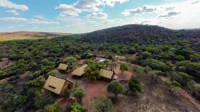 an aerial view of a house on a hill at Tholo Bush Stay