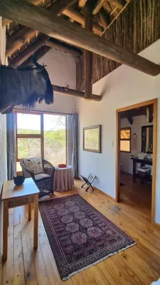 a living room with a cow head on the wall at Tholo Bush Stay