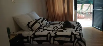 a bedroom with a bed with a cat sitting on it at Villa paradiso in Centurion