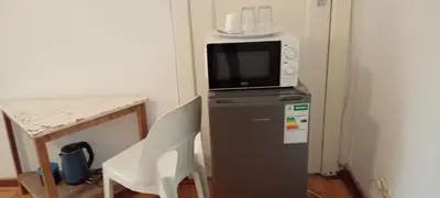 a microwave sitting on top of a refrigerator at Villa paradiso in Centurion
