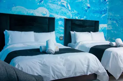 two beds with stuffed animals on them in a bedroom at Meriam Base Lodge in Kempton Park