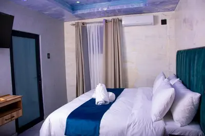 a bedroom with a large bed with white pillows at Meriam Base Lodge in Kempton Park