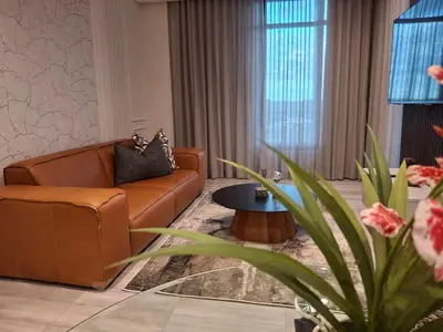 a living room with a couch and a table at 139 Menlyn Maine in Pretoria