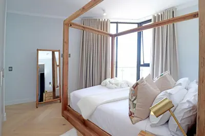 a bedroom with a canopy bed and a mirror at 1 Thango Executives Ellipse Gallileo in Midrand