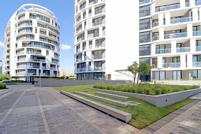 a park in front of two tall buildings at 1 Thango Executives Ellipse Gallileo in Midrand