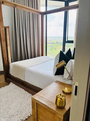 a bedroom with a bed and a large window at 1 Thango Executives Ellipse Gallileo in Midrand