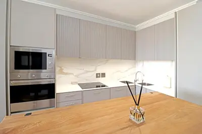 a kitchen with a wooden table and a counter top at 1 Thango Executives Ellipse Gallileo in Midrand