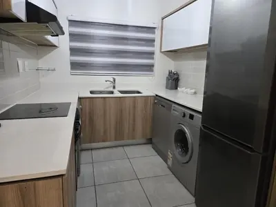 a kitchen with a stainless steel refrigerator and a dishwasher at The Blyde Luxury Apartments in Pretoria