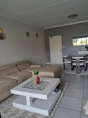 a living room with a couch and a table at The Blyde Luxury Apartments in Pretoria