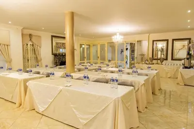 a large banquet hall with white tables and chairs at Angels Place Boutique Guesthouse in Pretoria