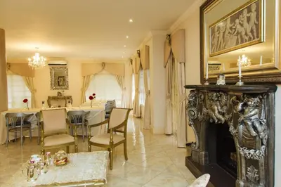 a dining room with a fireplace and a dining table at Angels Place Boutique Guesthouse in Pretoria