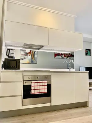 a kitchen with a stove and a sink at Awesome Apartment in Ellipse Waterfall Cassini in Midrand