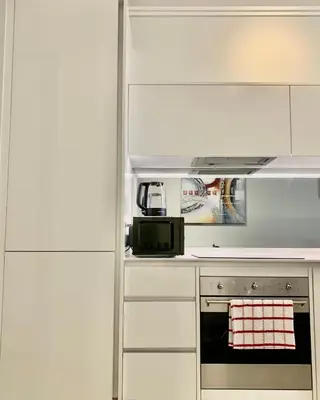 a kitchen with a stove and a microwave at Awesome Apartment in Ellipse Waterfall Cassini in Midrand