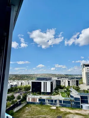 a view of a city from a building at Stunning Apartment in Ellipse Waterfall Midrand in Midrand