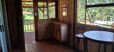 a small room with a table and a window at Bushbaby Cabin in Louwʼs Creek