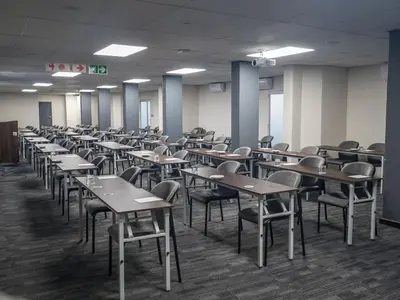 an empty classroom with desks and chairs in it at ANEW Hotel Centurion Pretoria in Centurion