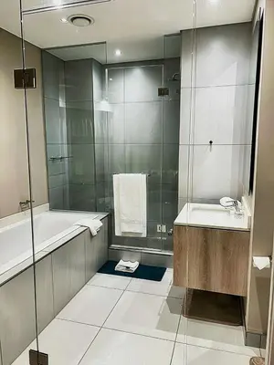 a bathroom with a tub and a sink and a shower at TrilogyatMenlyn in Pretoria