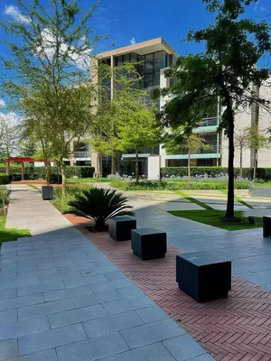 a park with benches and a building at TrilogyatMenlyn in Pretoria