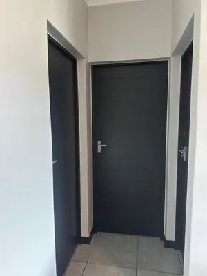 two black garage doors in a hallway at Comfortable stay in Midrand in Midrand