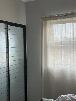 a bedroom with a window and a curtain at Comfortable stay in Midrand in Midrand