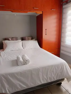 a bed with two towels on top of it at Ikhutseng Guesthouse in Graskop