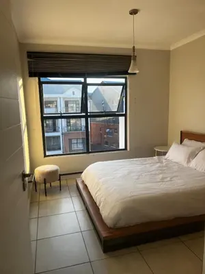 a bedroom with a bed and a large window at 2 Bedroom Penthouse at The Blyde in Pretoria