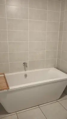 a white bath tub with a faucet in a bathroom at 2 Bedroom Penthouse at The Blyde in Pretoria