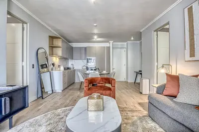 a living room with a couch and a table at Belle Vue at Ellipse in Midrand
